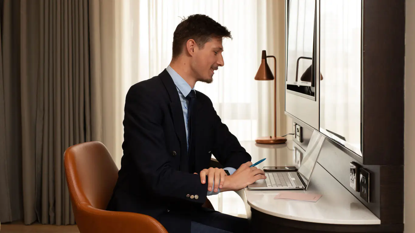 corporate man working at hotel desk